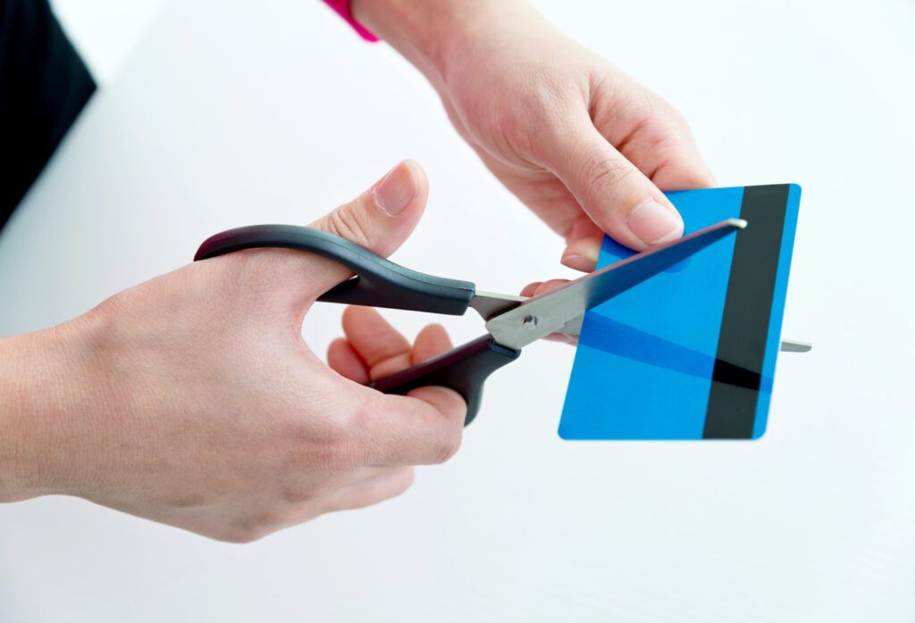 Woman hands cutting a credit card